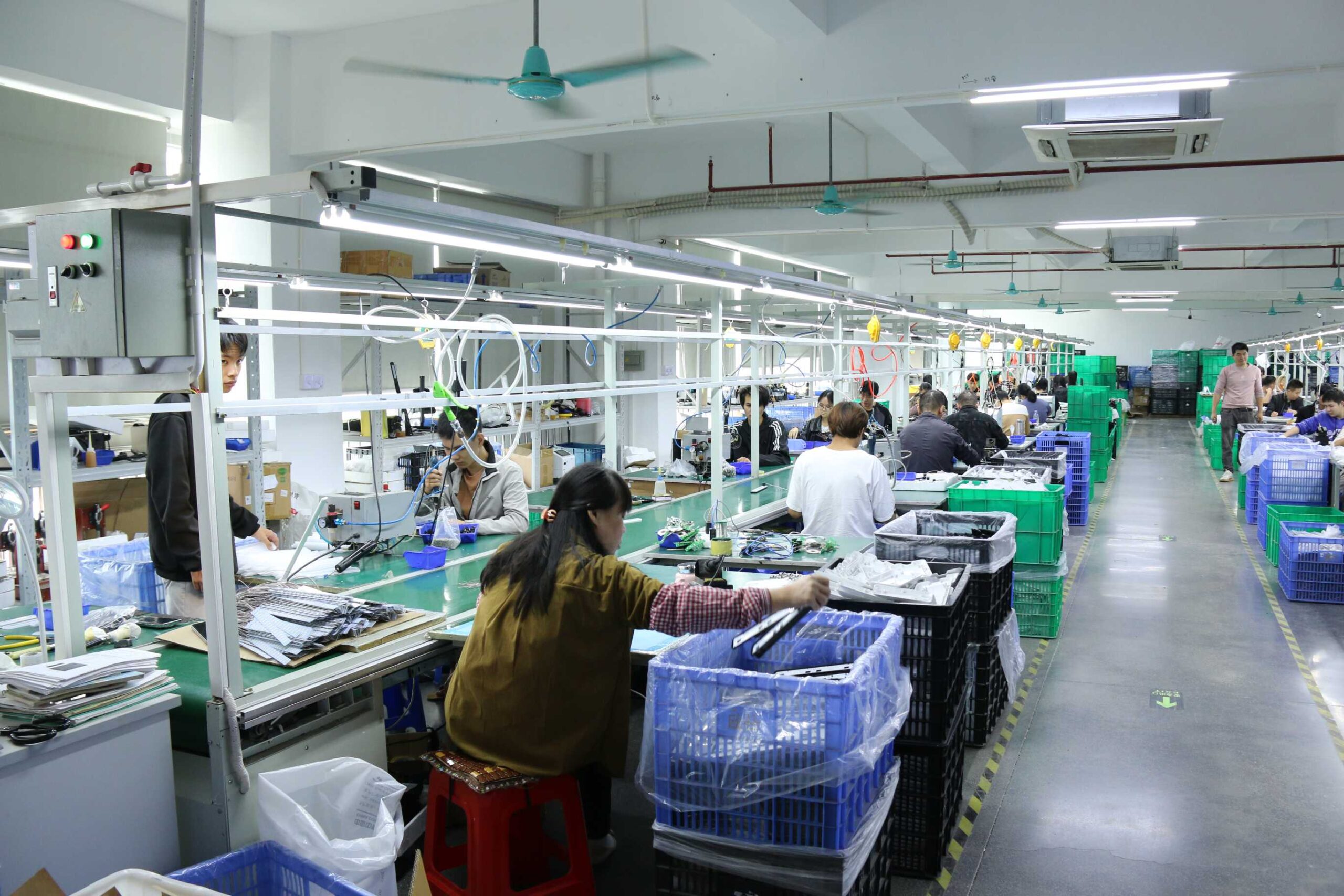 A modern LED desk lamp manufacturing facility with a well-organized production line, showcasing skilled workers assembling high-quality lighting products for global export.