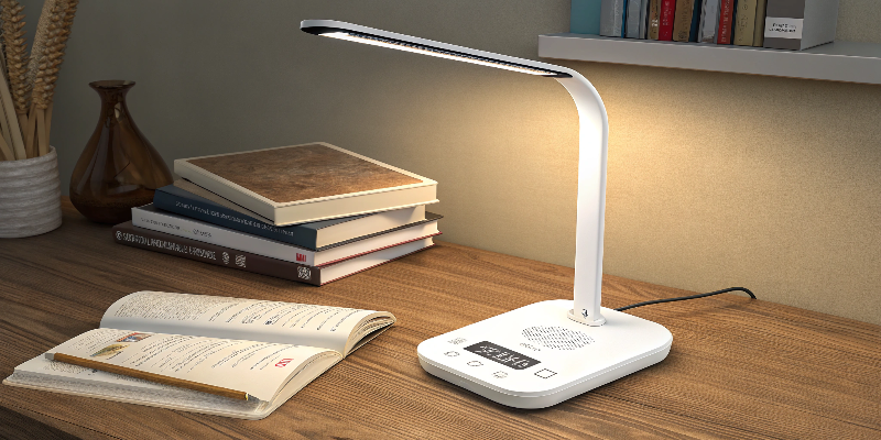 White LED desk lamp with touch controls, illuminating books and workspace