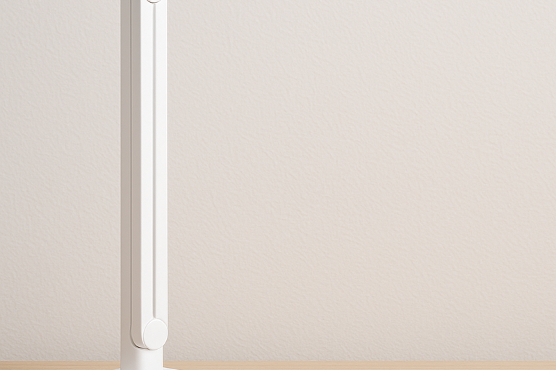 A desk lamp with a flexible arm shown folded into a compact vertical shape to save desk space