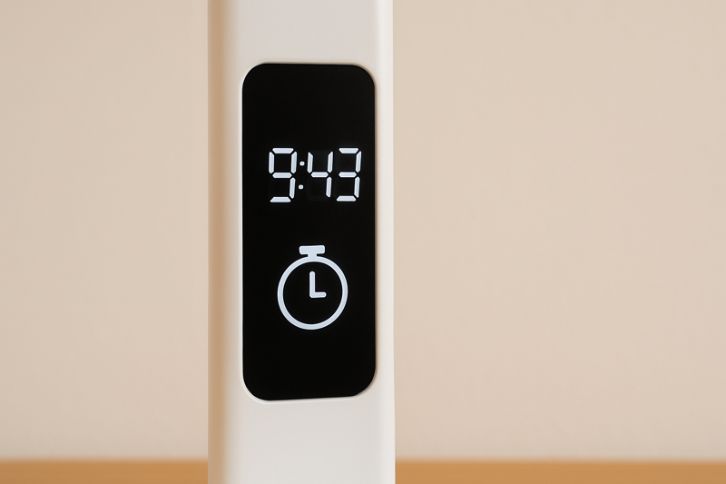 A close-up on the lamp's display screen showing the time and a timer icon, acting as a productivity hub