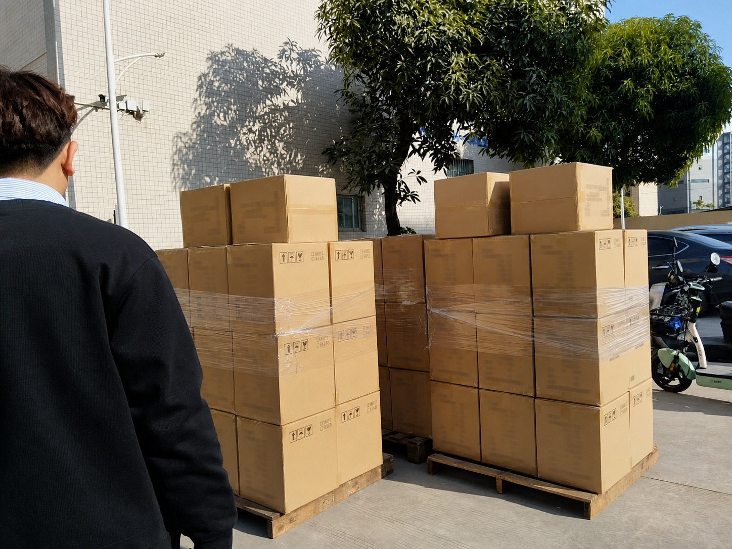 Packed LED lamp cartons grouped on pallets for loading