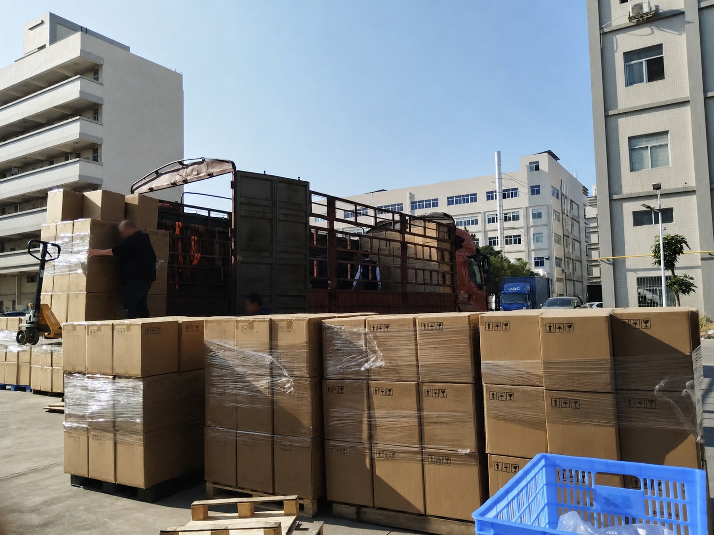 Packed lighting cartons being loaded at a factory dispatch area