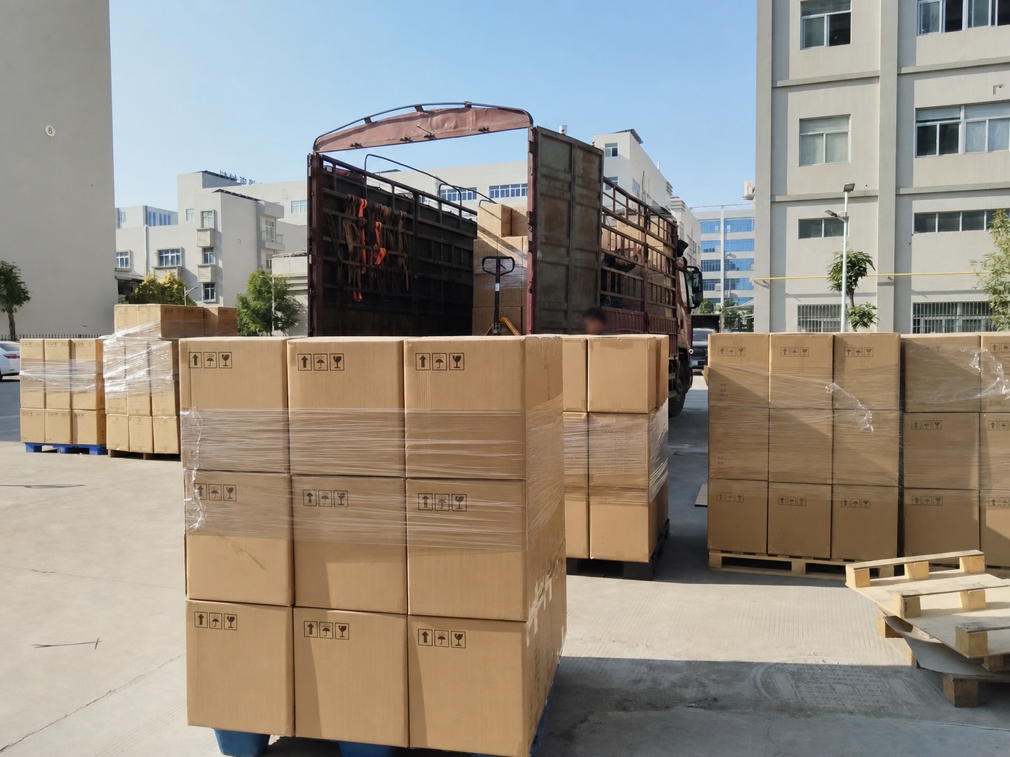Palletized LED lamp cartons prepared beside a collection truck